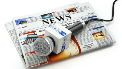 generic newspaper with news microphone sitting on top of it