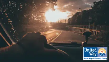 car driving on road toward sunset