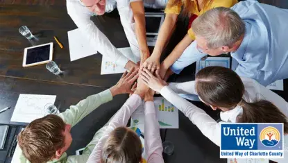 group of professionals with their hands together